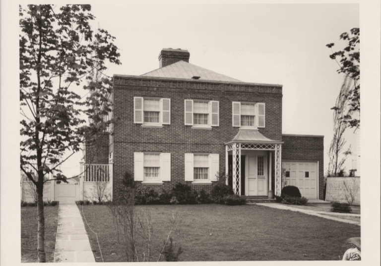 Black and white photograph of a brick house.