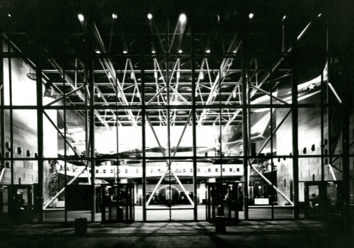 Black and white photograph of the National Air and Space Museum at night with the Apollo 11 Lunar Module